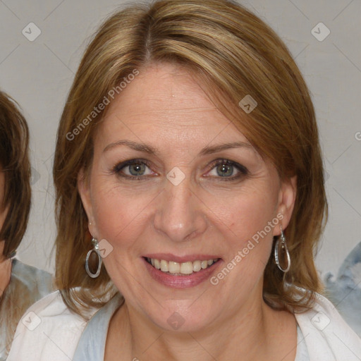 Joyful white adult female with medium  brown hair and blue eyes