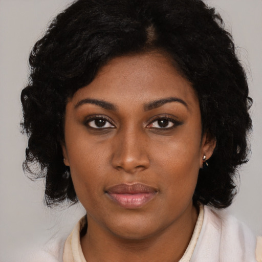 Joyful black young-adult female with medium  black hair and brown eyes