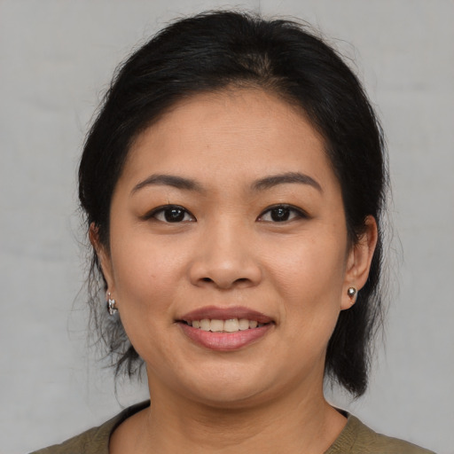 Joyful asian young-adult female with medium  brown hair and brown eyes