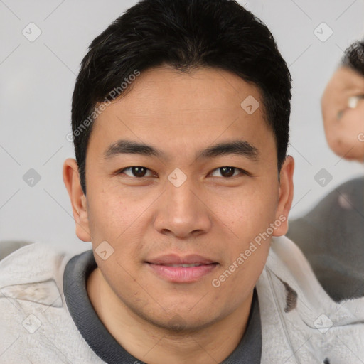 Joyful asian young-adult male with short  brown hair and brown eyes