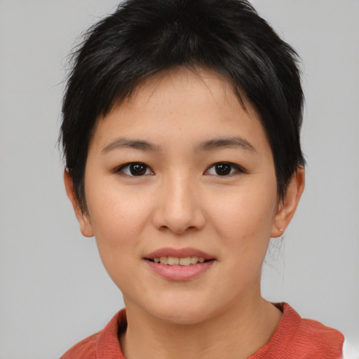Joyful asian young-adult female with short  brown hair and brown eyes
