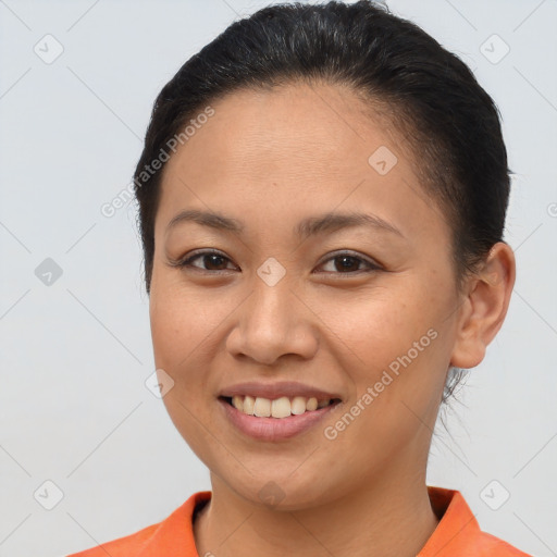 Joyful latino young-adult female with short  brown hair and brown eyes