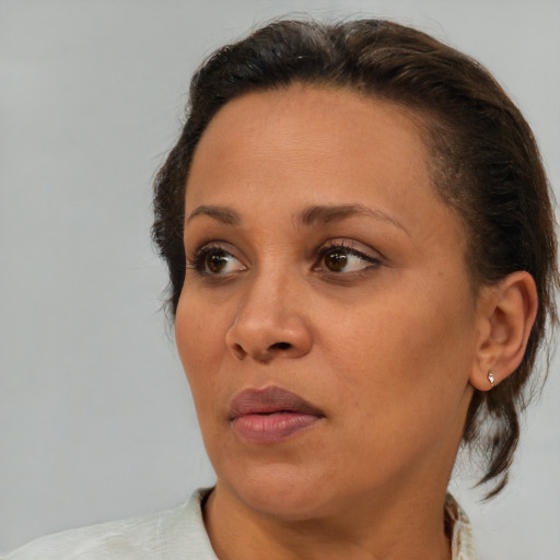 Neutral black young-adult female with medium  brown hair and brown eyes