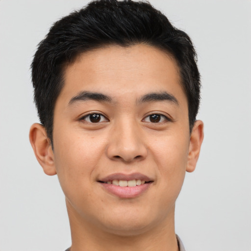 Joyful asian young-adult male with short  brown hair and brown eyes