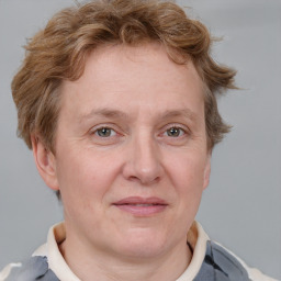 Joyful white adult female with short  brown hair and blue eyes