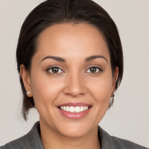 Joyful white young-adult female with medium  brown hair and brown eyes