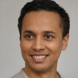 Joyful latino young-adult male with short  brown hair and brown eyes