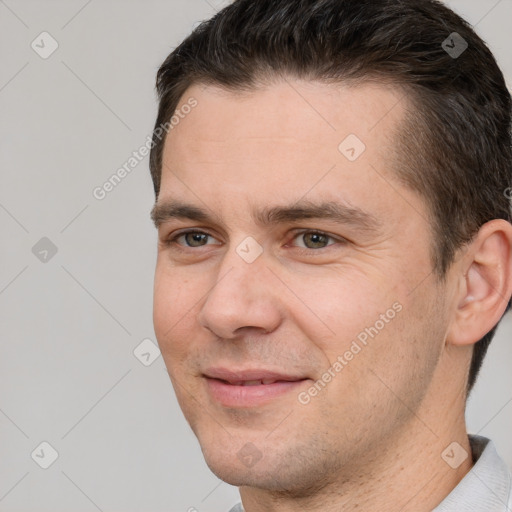 Joyful white adult male with short  brown hair and brown eyes