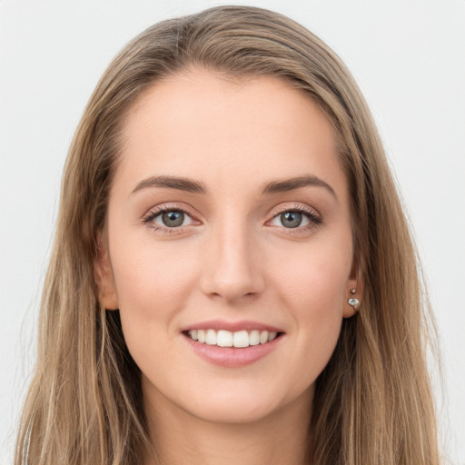 Joyful white young-adult female with long  brown hair and green eyes