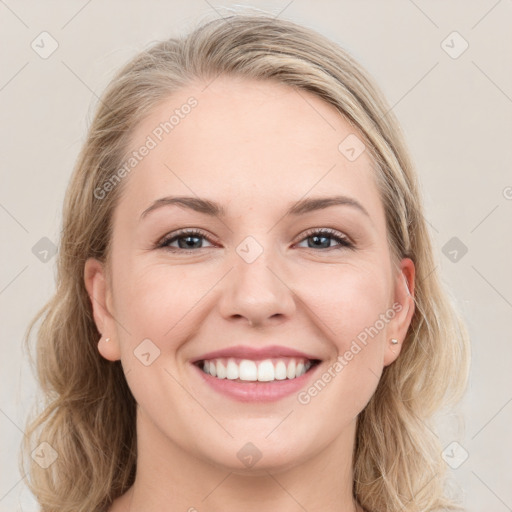 Joyful white young-adult female with long  brown hair and blue eyes