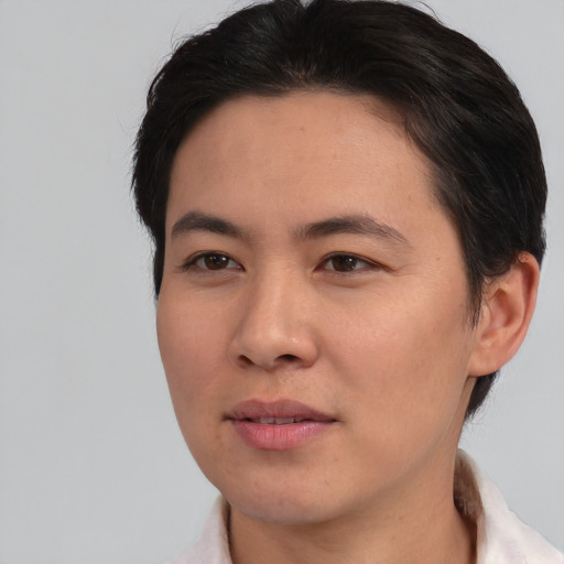 Joyful asian young-adult female with short  brown hair and brown eyes