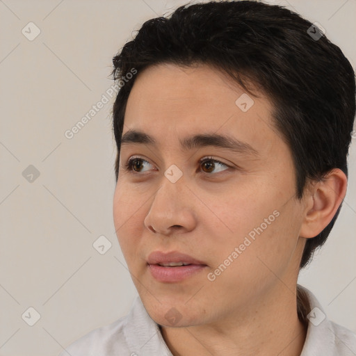 Joyful white young-adult male with short  black hair and brown eyes