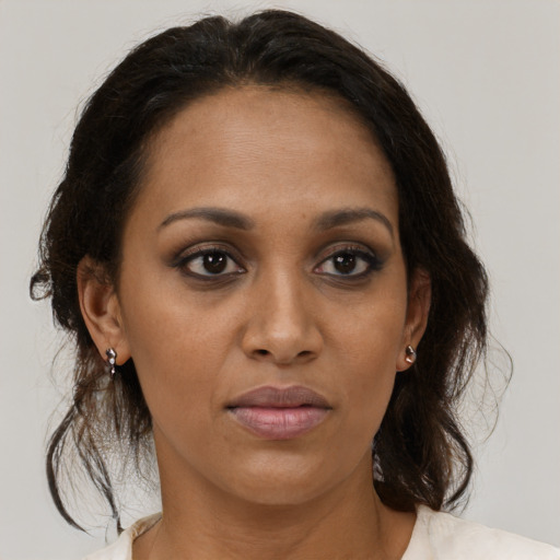 Joyful black adult female with medium  brown hair and brown eyes