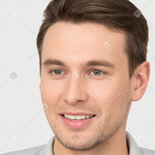 Joyful white young-adult male with short  brown hair and brown eyes