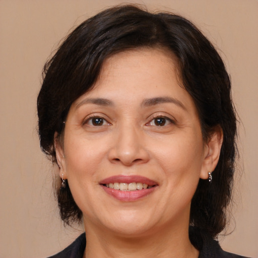 Joyful white adult female with medium  brown hair and brown eyes