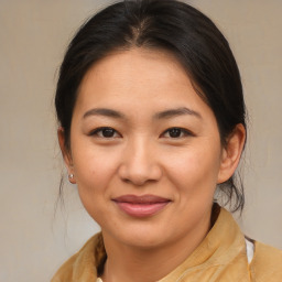 Joyful asian young-adult female with medium  brown hair and brown eyes