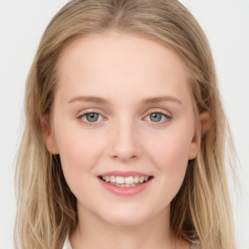 Joyful white young-adult female with long  brown hair and blue eyes