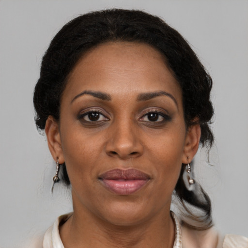 Joyful black young-adult female with medium  brown hair and brown eyes