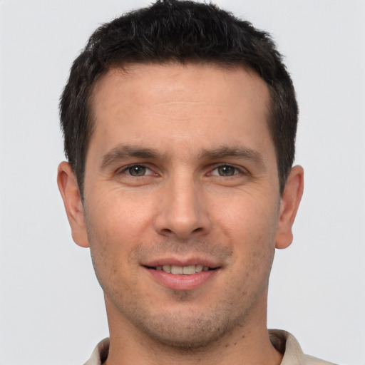 Joyful white young-adult male with short  brown hair and brown eyes