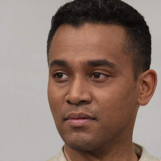 Neutral latino young-adult male with short  black hair and brown eyes