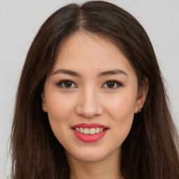 Joyful asian young-adult female with long  brown hair and brown eyes