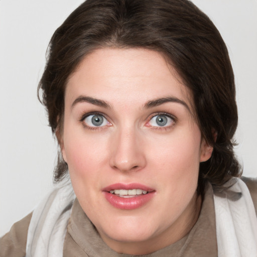 Joyful white young-adult female with medium  brown hair and blue eyes