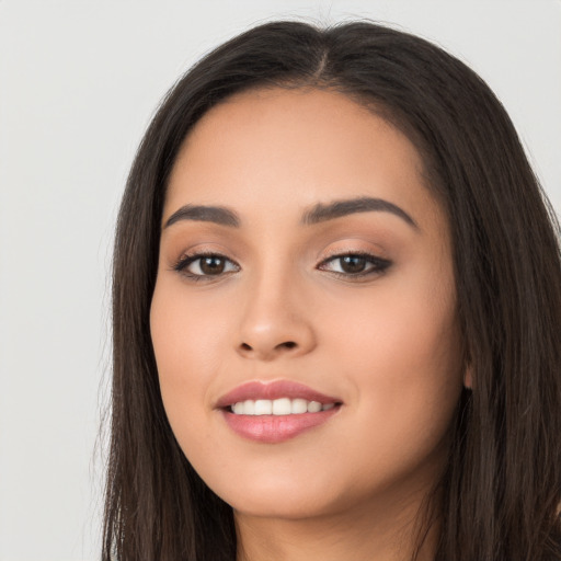 Joyful white young-adult female with long  black hair and brown eyes