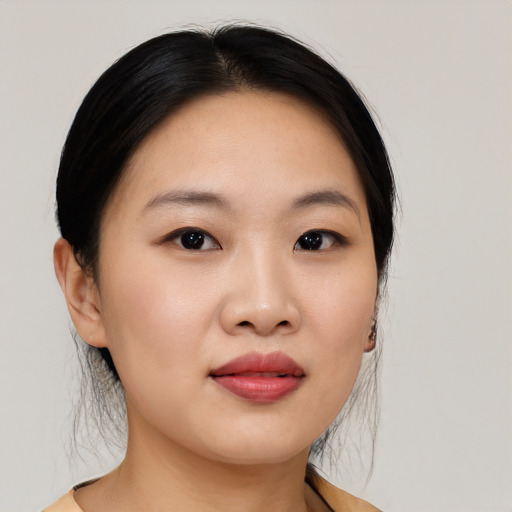 Joyful asian young-adult female with medium  black hair and brown eyes