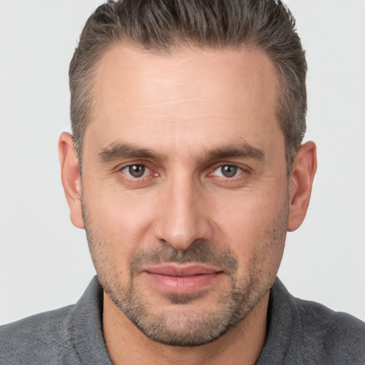 Joyful white adult male with short  brown hair and brown eyes