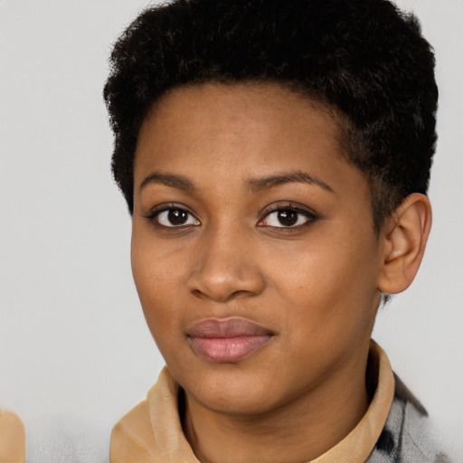 Joyful black young-adult female with short  black hair and brown eyes