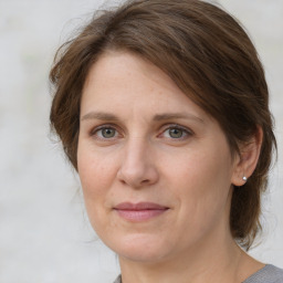 Joyful white adult female with medium  brown hair and grey eyes