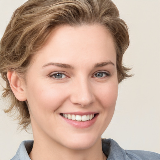 Joyful white young-adult female with medium  brown hair and blue eyes