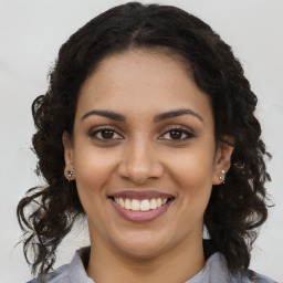 Joyful latino young-adult female with long  brown hair and brown eyes