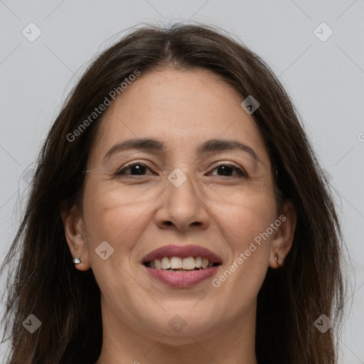 Joyful white adult female with long  brown hair and brown eyes