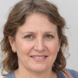 Joyful white adult female with medium  brown hair and grey eyes