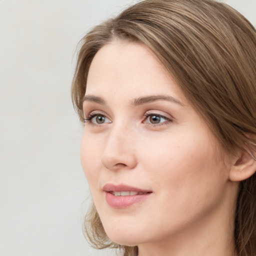 Joyful white young-adult female with long  brown hair and grey eyes