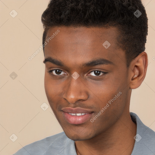 Joyful black young-adult male with short  brown hair and brown eyes