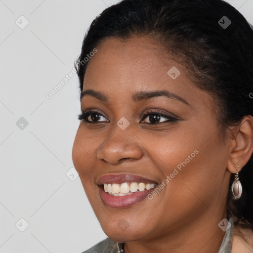 Joyful black young-adult female with long  brown hair and brown eyes