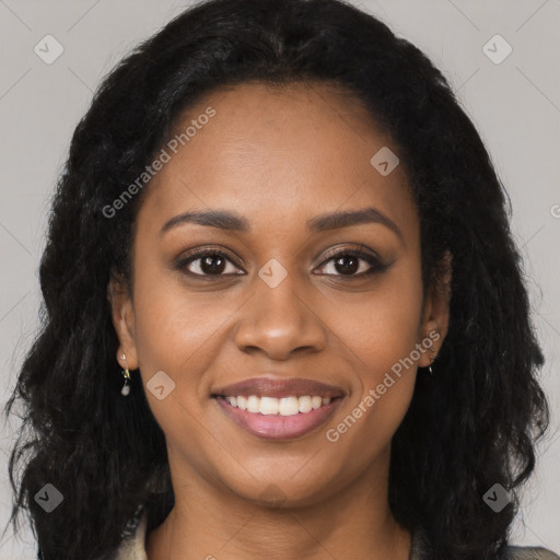 Joyful black young-adult female with long  black hair and brown eyes