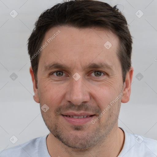 Joyful white adult male with short  brown hair and brown eyes