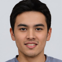 Joyful asian young-adult male with short  black hair and brown eyes