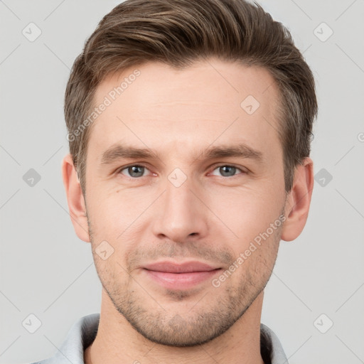 Joyful white young-adult male with short  brown hair and grey eyes