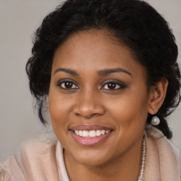 Joyful black young-adult female with long  brown hair and brown eyes