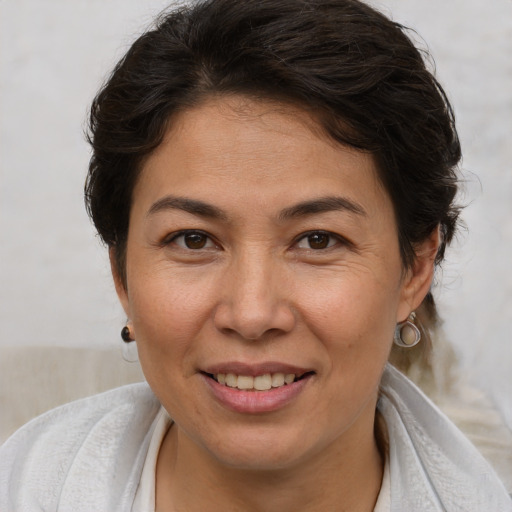 Joyful white adult female with short  brown hair and brown eyes
