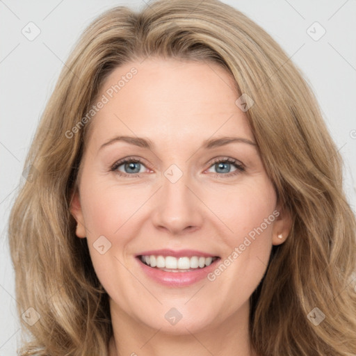 Joyful white young-adult female with long  brown hair and grey eyes