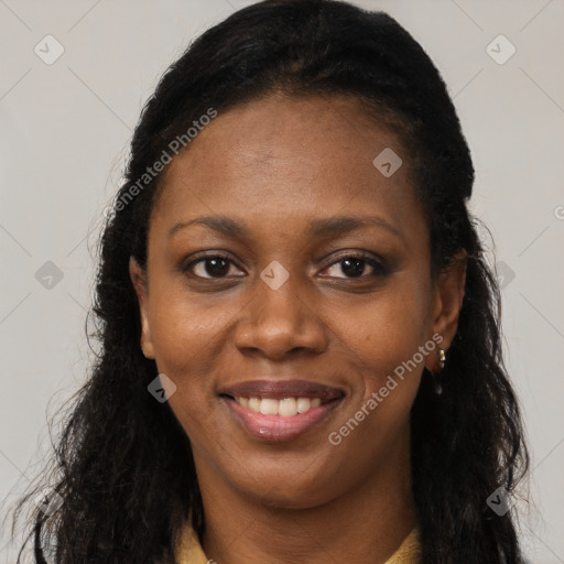 Joyful black young-adult female with long  black hair and brown eyes