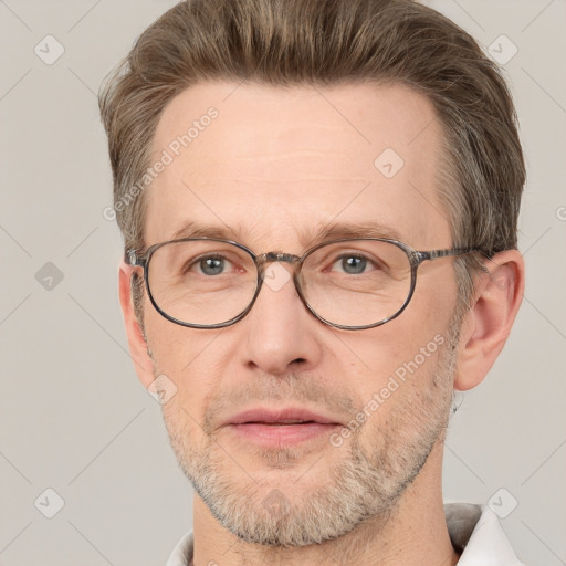 Joyful white adult male with short  brown hair and grey eyes