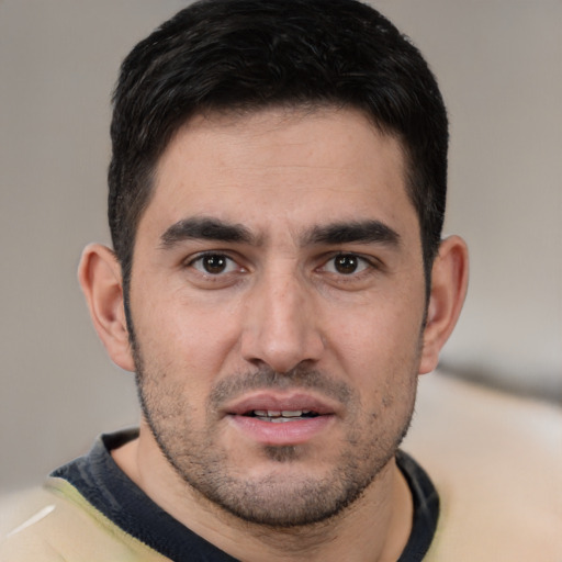 Joyful white young-adult male with short  black hair and brown eyes
