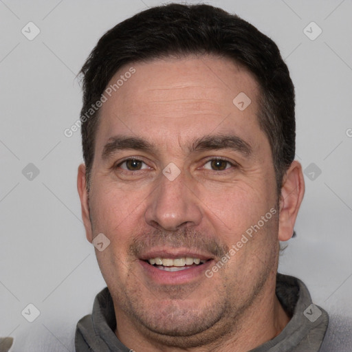 Joyful white adult male with short  brown hair and brown eyes