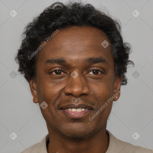 Joyful black adult male with short  black hair and brown eyes